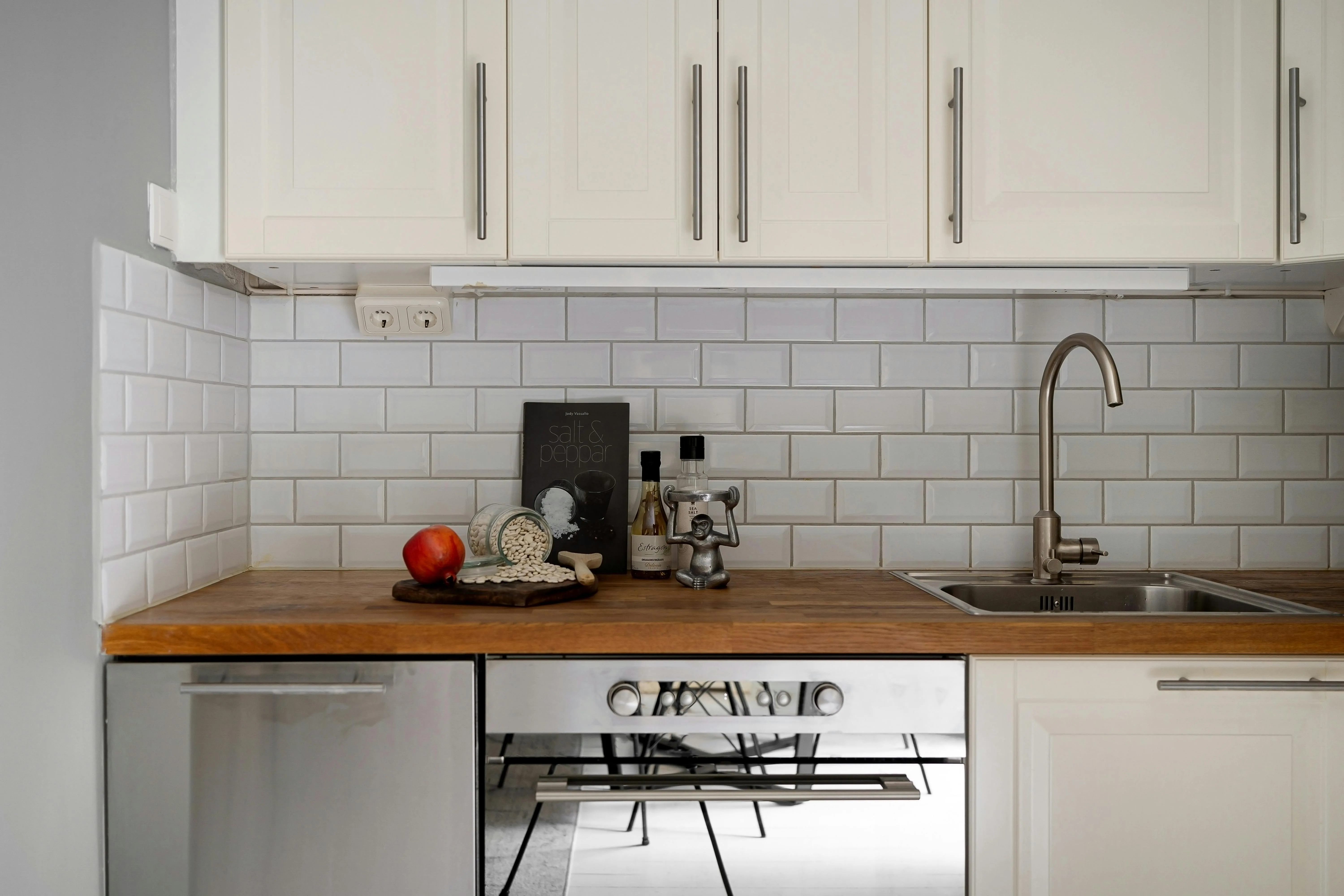 Clean white kitchen backsplash tile installation